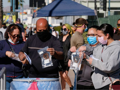 Californians dropping their test kits into a receptacle at a coronavirus testing site